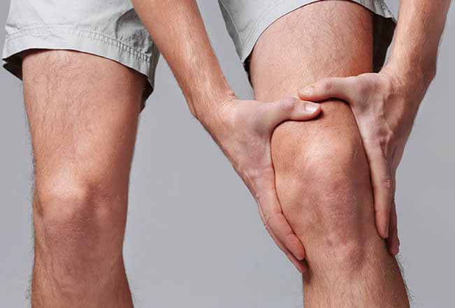 Male holding knee in pain